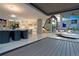 Bright open-plan layout with modern kitchen and living area, featuring access to outdoor deck through sliding glass doors at 1175 S Jackson St, Denver, CO 80210