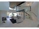 Spacious living room featuring a modern fireplace, elegant staircase, and comfortable lounge area at 1175 S Jackson St, Denver, CO 80210