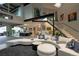 Bright living room featuring a modern staircase, unique art, and curved white sofa creating a stylish and inviting space at 1175 S Jackson St, Denver, CO 80210