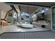 Bright open-plan living space with sleek fireplace, vaulted ceilings, modern art, and deck access through sliding glass doors at 1175 S Jackson St, Denver, CO 80210