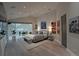 Spacious main bedroom with hardwood floors, tray ceiling, and modern decor at 1175 S Jackson St, Denver, CO 80210