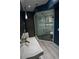 Modern glass enclosed shower with gray and white mosaic tile flooring, wall bench and stylish shower head at 1175 S Jackson St, Denver, CO 80210