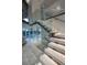 Modern staircase with glass railings and floating steps, complemented by natural light and open design at 1175 S Jackson St, Denver, CO 80210