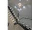 Modern illuminated staircase with glass railings leads to the upper level of the home at 1175 S Jackson St, Denver, CO 80210