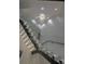 Illuminated staircase with glass railing and modern light fixture in a modern home at 1175 S Jackson St, Denver, CO 80210