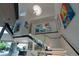 Modern staircase illuminated with designer lighting leading to the upper level featuring an art gallery at 1175 S Jackson St, Denver, CO 80210