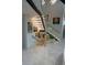Modern staircase with glass railings, illuminated steps, and art gallery wall at 1175 S Jackson St, Denver, CO 80210