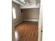 The light-filled bedroom features hardwood floors and a ceiling fan at 6139 Broadway S, Littleton, CO 80121