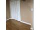 View of bedroom with hardwood floors and closet with white bi-fold doors at 6139 Broadway S, Littleton, CO 80121