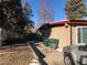 View of home exterior and driveway with trash cans at 6139 Broadway S, Littleton, CO 80121