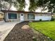 Single-story home with manicured lawn and rock-lined flower beds at 6139 Broadway S, Littleton, CO 80121