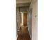 Hallway with hardwood floors and neutral colored walls at 6139 Broadway S, Littleton, CO 80121