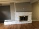 A white brick fireplace is the centerpiece of this living room with hardwood flooring at 6139 Broadway S, Littleton, CO 80121