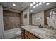 Bathroom with shower/tub combo, granite vanity, and granite vanity in a modern neutral palette at 611 Village Rd # 620, Breckenridge, CO 80424