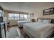 Bright bedroom featuring two queen beds, large window, and dark wood laminate flooring at 611 Village Rd # 620, Breckenridge, CO 80424