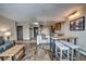 Spacious living room with a breakfast bar, leather couch and hardwood floors throughout at 611 Village Rd # 620, Breckenridge, CO 80424