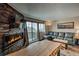 Bright living room offers a fireplace, tv, leather couch and a sliding door to the balcony at 611 Village Rd # 620, Breckenridge, CO 80424