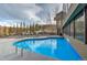 Relax and unwind in this outdoor pool with seating and forest views at 611 Village Rd # 620, Breckenridge, CO 80424