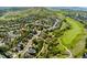 Aerial view showcasing community with green spaces, golf course, and mountain backdrop at 1825 Cooper Ct, Castle Rock, CO 80109