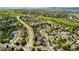 Aerial view showcasing community with green spaces, golf course, and mountain backdrop at 1825 Cooper Ct, Castle Rock, CO 80109
