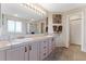 Bathroom featuring a double vanity, large mirror with decorative lighting and tile countertops at 1825 Cooper Ct, Castle Rock, CO 80109