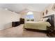 A cozy bedroom with a vaulted ceiling, carpet, and a large window showcasing natural light at 1825 Cooper Ct, Castle Rock, CO 80109