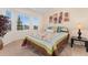 Cozy bedroom with a bay window, comfortable bed, colorful quilt, and decorative wall art at 1825 Cooper Ct, Castle Rock, CO 80109