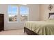 Bright bedroom featuring two large windows, neutral tones, and plush carpeting for a comfortable feel at 1825 Cooper Ct, Castle Rock, CO 80109