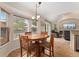 Inviting dining area with a wooden table, large windows, and views of the outdoor landscape at 1825 Cooper Ct, Castle Rock, CO 80109