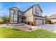 Charming two-story home with well-manicured lawn, mature landscaping, and three-car garage at 1825 Cooper Ct, Castle Rock, CO 80109