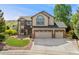 Charming two-story home featuring a three-car garage, landscaped front yard, and classic architectural details at 1825 Cooper Ct, Castle Rock, CO 80109