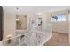 Upstairs hallway with white railing, carpeted floor, and a view of the lower level at 1825 Cooper Ct, Castle Rock, CO 80109