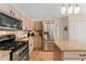 Bright kitchen with stainless steel appliances, granite countertops, and center island with modern light fixtures at 1825 Cooper Ct, Castle Rock, CO 80109