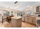 An open kitchen with a center island, wood floors, stainless appliances, granite countertops and breakfast nook at 1825 Cooper Ct, Castle Rock, CO 80109