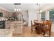 The kitchen features a stainless refrigerator, granite countertops, an island, and a dining area at 1825 Cooper Ct, Castle Rock, CO 80109
