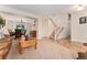 Comfortable living room flowing into dining space, staircase with carpet, and neutral decor at 1825 Cooper Ct, Castle Rock, CO 80109