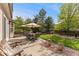 Inviting patio with outdoor dining set, chairs, and lush green backyard at 1825 Cooper Ct, Castle Rock, CO 80109