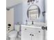 Stylish bathroom featuring modern fixtures, a round mirror, and a clean, elegant design at 1740 S Ammons St # C, Lakewood, CO 80232