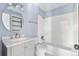 This updated bathroom features a tub and shower combination and stylish fixtures at 1740 S Ammons St # C, Lakewood, CO 80232