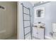 This bathroom features updated fixtures, a ladder for towel storage and a walk-in shower at 1740 S Ammons St # C, Lakewood, CO 80232