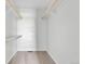 Walk-in closet with neutral carpeting, built-in shelving and wooden closet rod at 1740 S Ammons St # C, Lakewood, CO 80232