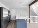 Kitchen island with stainless steel appliances and quartz countertops offer a modern design at 1740 S Ammons St # C, Lakewood, CO 80232