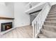 Bright living room with a fireplace, staircase and second floor balcony at 1740 S Ammons St # C, Lakewood, CO 80232
