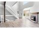 Inviting living room features a fireplace, white staircase, and plenty of natural light at 1740 S Ammons St # C, Lakewood, CO 80232