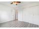 Bright bedroom featuring a ceiling fan, closet, and wood-look flooring for added warmth at 5711 W 92Nd Ave # 47, Westminster, CO 80031