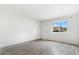 Bright bedroom with wood-look floors, a large window, and a convenient door for easy access at 5711 W 92Nd Ave # 47, Westminster, CO 80031
