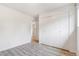 Bedroom featuring a large closet with bifold doors and wood laminate flooring at 5711 W 92Nd Ave # 47, Westminster, CO 80031