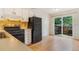 Functional kitchen with white cabinets, black appliances, and a sliding glass door to the outside at 5711 W 92Nd Ave # 47, Westminster, CO 80031