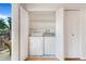 Convenient laundry area with a full-size washer and dryer, complete with storage shelves at 5711 W 92Nd Ave # 47, Westminster, CO 80031