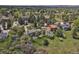 Aerial view of the property surrounded by lush greenery and mature trees in a neighborhood at 7605 E Windlawn Way, Parker, CO 80134